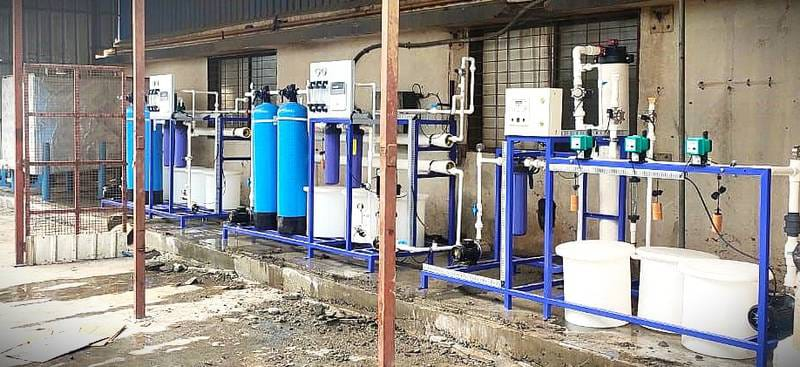 Engineers analyzing water treatment system blueprints